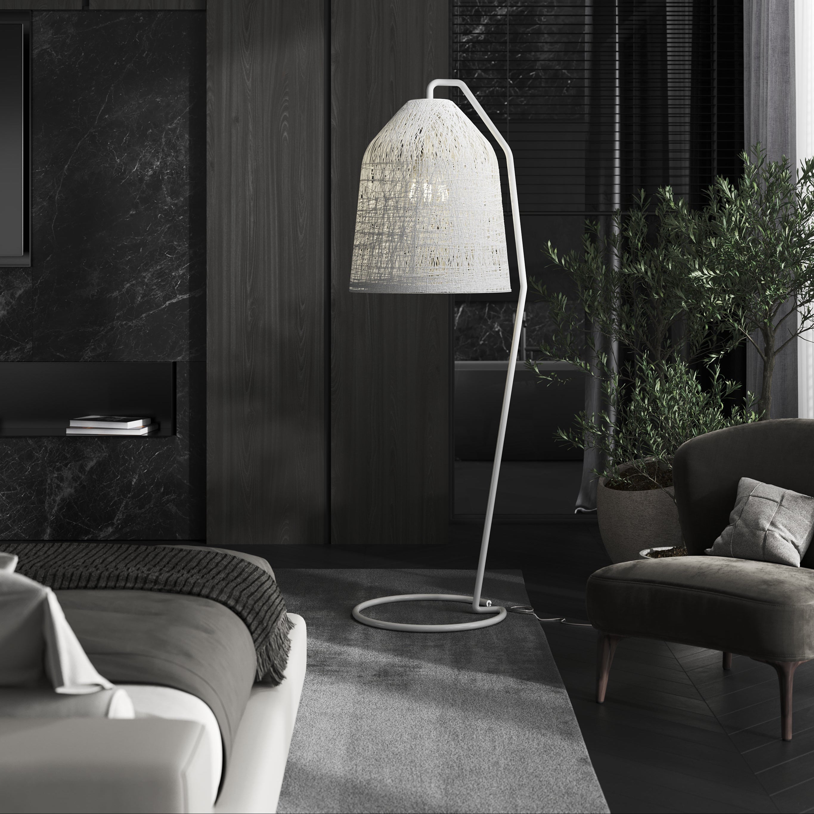Lampada da terra Karman Black Out in una camera da letto accanto a una poltrona.